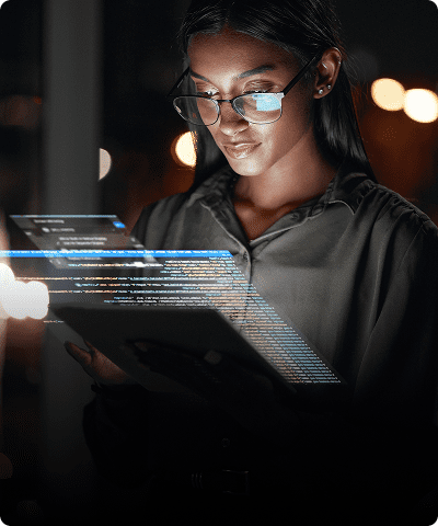 Woman reading digital data on tablet screen.
